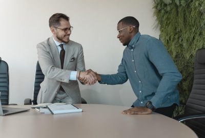 Two men shaking hands in job interview
