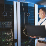 Critical facilities technician monitoring data center systems to protect uptime