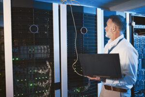 Critical facilities technician monitoring data center systems to protect uptime