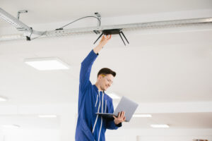 DAS technician installing in-building wireless equipment inside a commercial facility