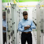 Data center commissioning engineer reviewing MEP testing plan before project handoff