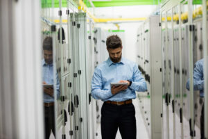 Data center commissioning engineer reviewing MEP testing plan before project handoff
