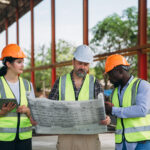 Data center construction staffing team reviewing plans for MEP installation and project turnover