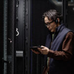 Data center professional reviewing server room operations for mission-critical hiring needs