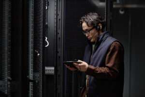 Data center professional reviewing server room operations for mission-critical hiring needs