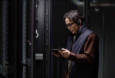 Data center professional reviewing server room operations for mission-critical hiring needs
