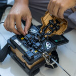 Fiber splicer preparing fiber optic cables for broadband network turn-up