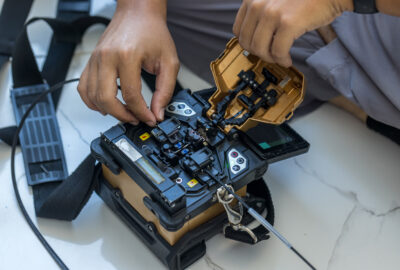 Fiber splicer preparing fiber optic cables for broadband network turn-up