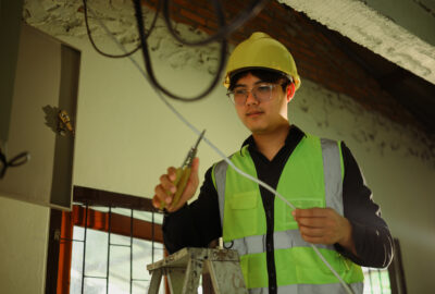 In-building wireless technician installing DAS equipment for indoor connectivity