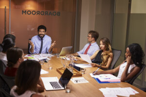 BEAD program manager reviewing broadband deployment plans with a cross-functional infrastructure team