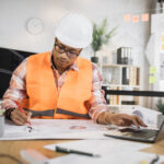 Fiber project coordinator reviewing OSP permits and construction documents
