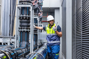 Data center technician inspecting liquid cooling equipment before high-density workloads go live