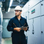 PE electrical engineer reviewing data center power design near switchgear