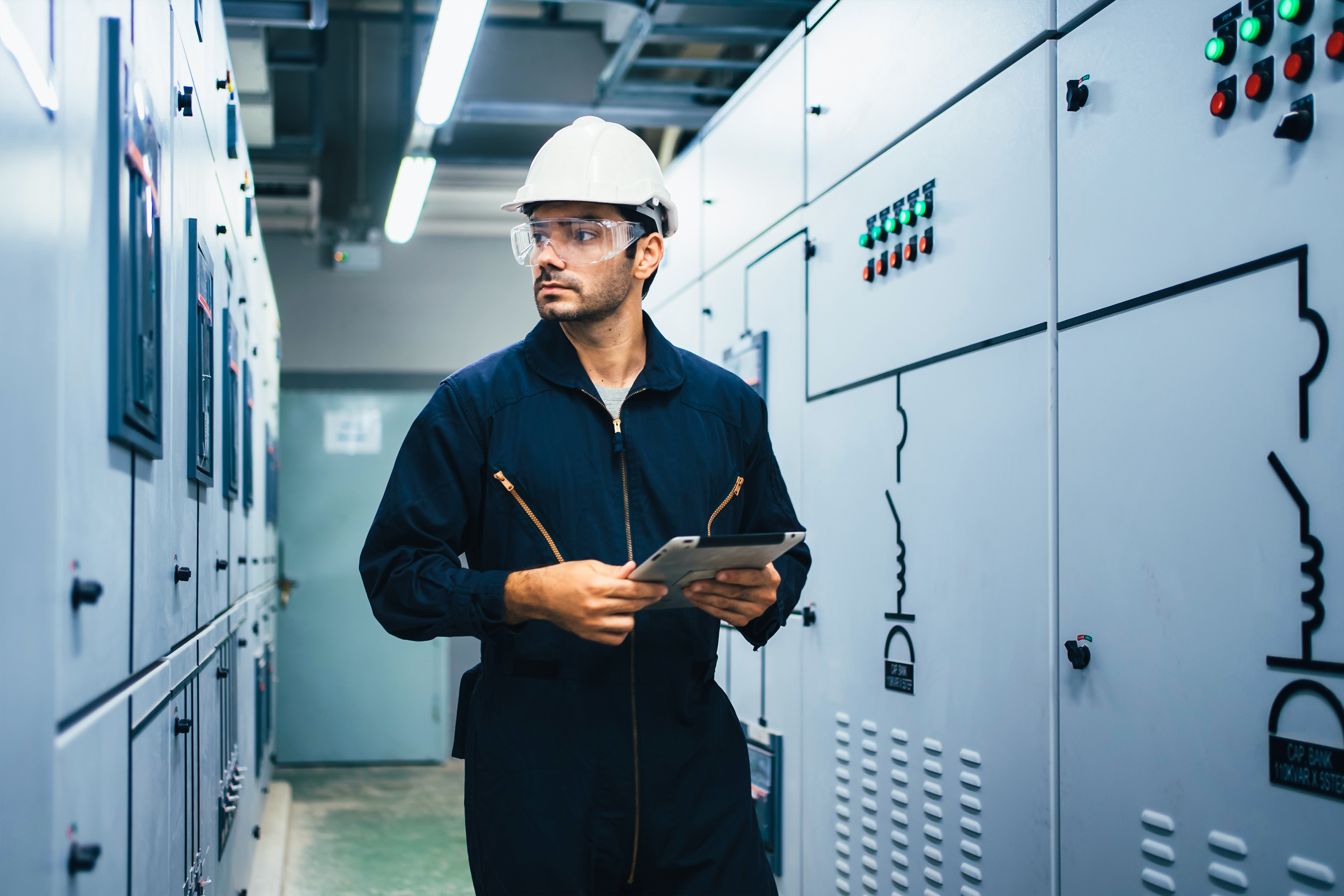 PE electrical engineer reviewing data center power design near switchgear