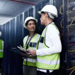 Data center fit-out team working around server racks and infrastructure