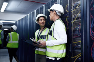 Data center fit-out team working around server racks and infrastructure