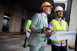 Project manager reviewing data center construction plans with engineers on site
