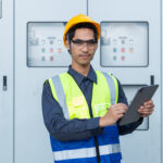 Data center power engineer reviewing switchgear and critical power systems