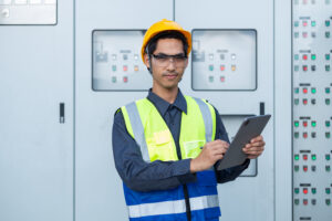 Data center power engineer reviewing switchgear and critical power systems