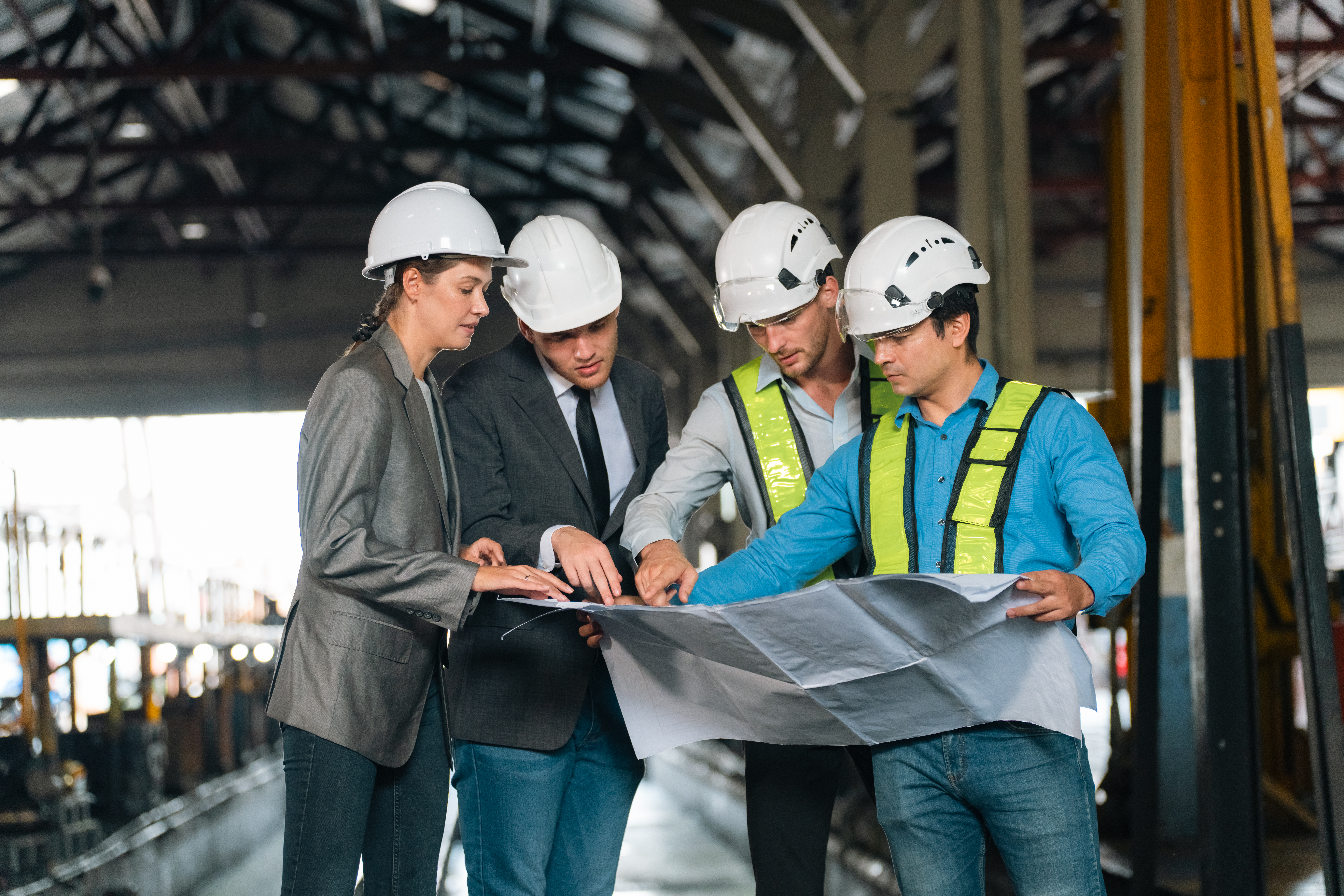 Director of data center construction reviewing plans with a project team