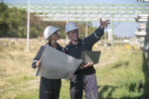 Fiber design engineer and OSP engineer reviewing broadband network plans and field routes