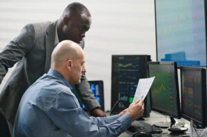 RF optimization manager reviewing 5G network performance with wireless engineers