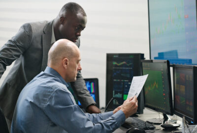 RF optimization manager reviewing 5G network performance with wireless engineers