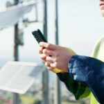 Wireless regional operations director reviewing field operations near telecommunications infrastructure