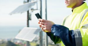 Wireless regional operations director reviewing field operations near telecommunications infrastructure