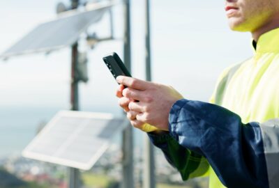 Wireless regional operations director reviewing field operations near telecommunications infrastructure