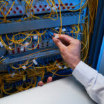 Data center fiber technician working on high-capacity fiber infrastructure
