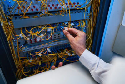 Data center fiber technician working on high-capacity fiber infrastructure