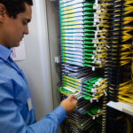 Data center technician working with high-density structured cabling
