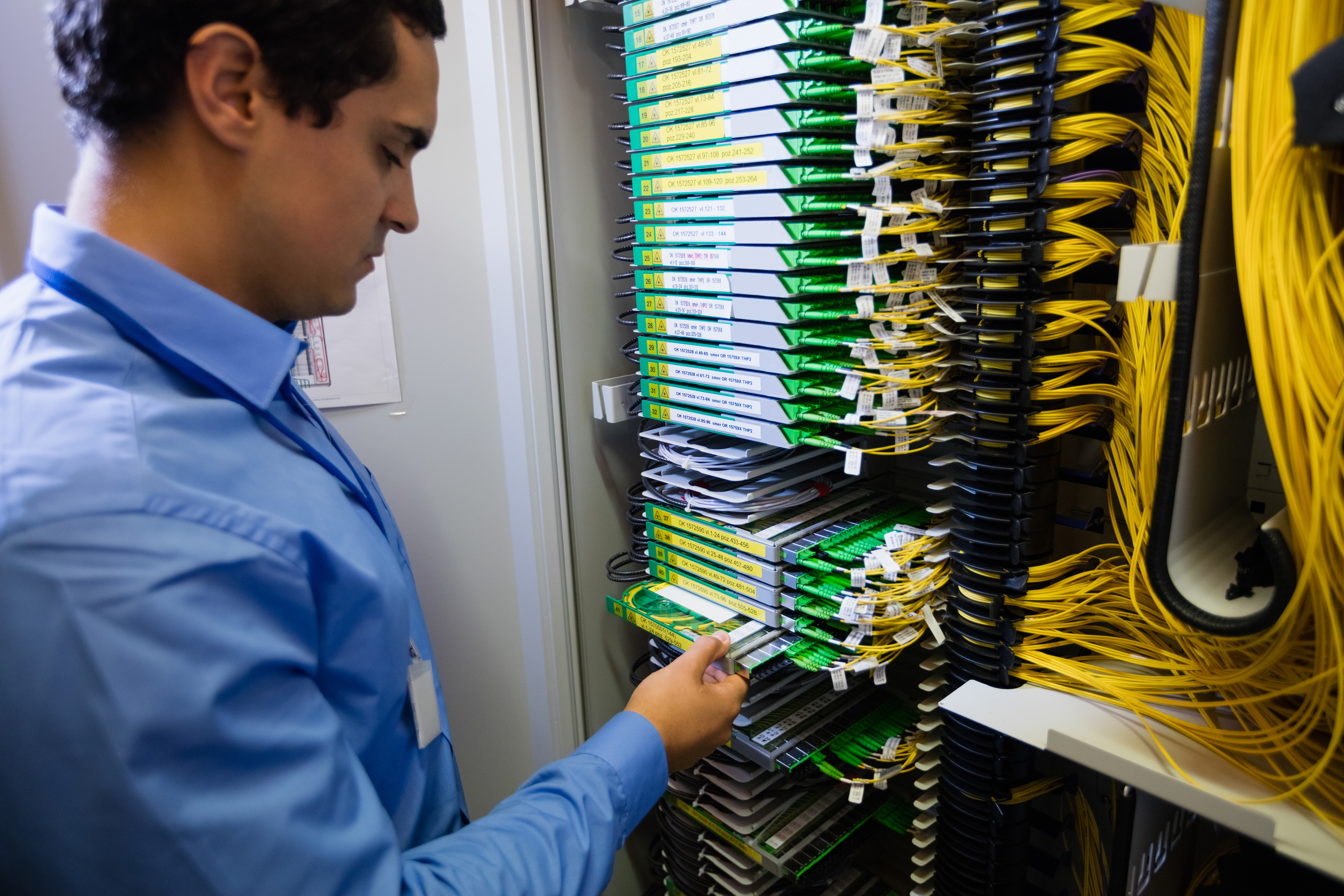 Data center technician working with high-density structured cabling