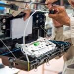 Fiber network maintenance technician testing an active fiber connection