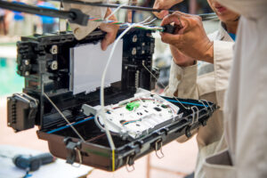 Fiber network maintenance technician testing an active fiber connection