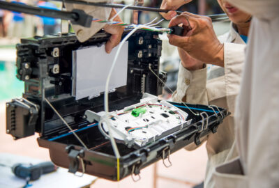Fiber network maintenance technician testing an active fiber connection