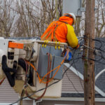Fiber technician repairing network infrastructure after a storm outage
