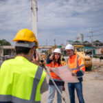 OSP construction coordinator reviewing a fiber construction project in the field