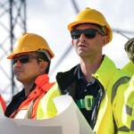 Tower foreman leading a wireless construction crew at a cellular tower