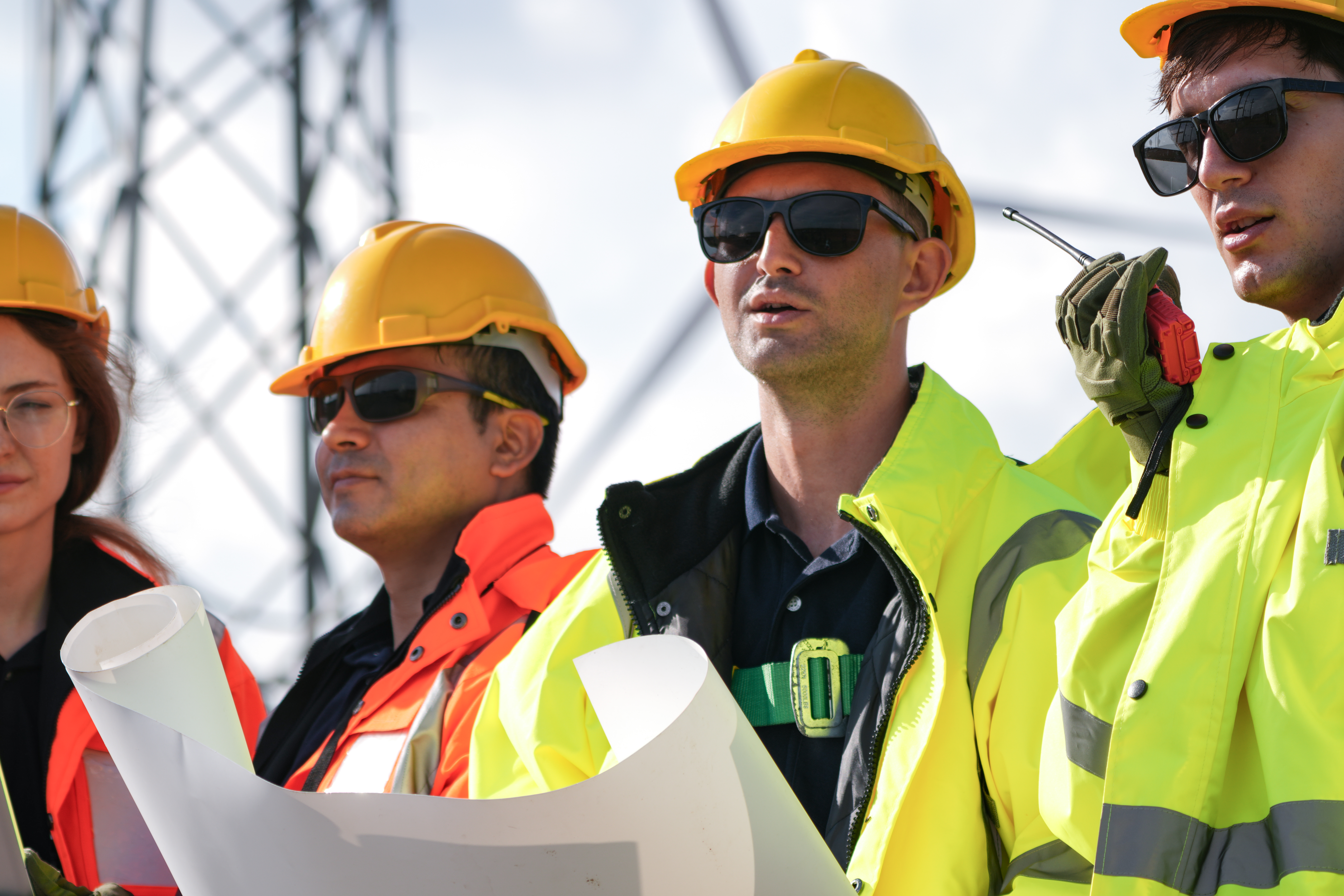 Tower foreman leading a wireless construction crew at a cellular tower