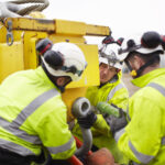 Underground fiber construction crew installing conduit for a high-capacity network