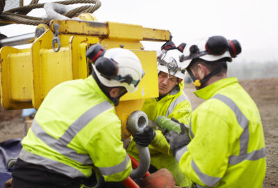 Underground fiber construction crew installing conduit for a high-capacity network