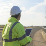 Wireless permitting manager reviewing telecom site plans for wireless deployment