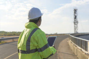 Wireless permitting manager reviewing telecom site plans for wireless deployment