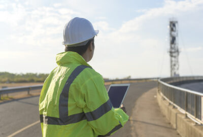 Wireless permitting manager reviewing telecom site plans for wireless deployment