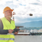 Wireless QA/QC inspector reviewing equipment at a cellular site