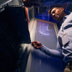 Technician servicing a server rack inside a small edge data center